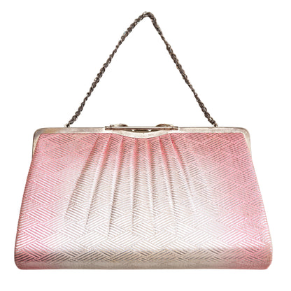 Pink and silver handbag with a chain strap on a white background