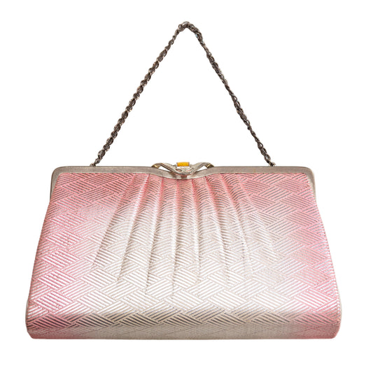 Pink and silver clutch bag with a chain strap on a white background