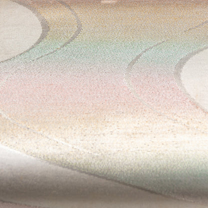 Pastel silk clutch bag with metallic accents.