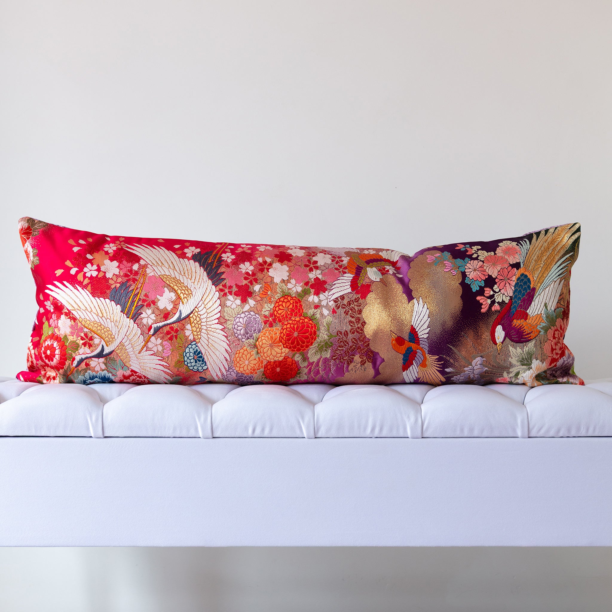 Red and purple silk kimono bolster cushion featuring cranes and layered florals, crafted from vintage Japanese silk