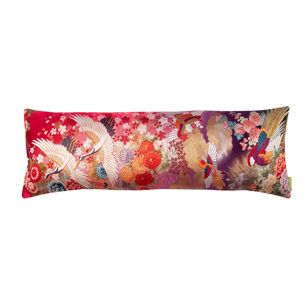 Red gold silk kimono bolster cushion featuring embroidered flying cranes and purple velvet edges by Hunted and Stuffed