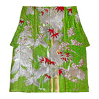 Close-up of intricate silk weave and vintage floral embroidery highlighting luxurious texture and subtle color variations.