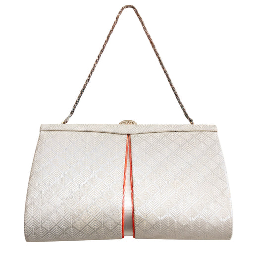 White textured vintage Japanese silk handbag with a silver chain strap and fancy clasp on a white background