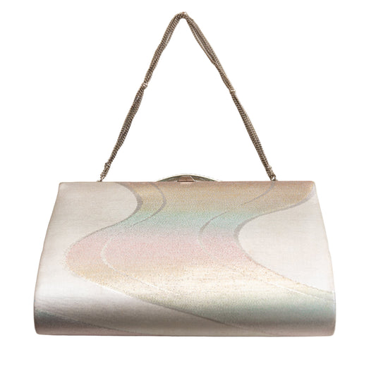 Vintage silvery Japanese silk clutch bag with a iridescent river design on a white background