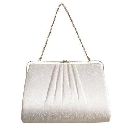 Silver glittery handbag with a chain strap on a white background
