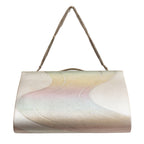 Close-up of iridescent river surface pattern on vintage silver kimono clutch with subtle metallic sheen and textured