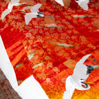 Close-up of vibrant multicolour silk fabric highlighting intricate vintage kimono-inspired embroidery details on the throw