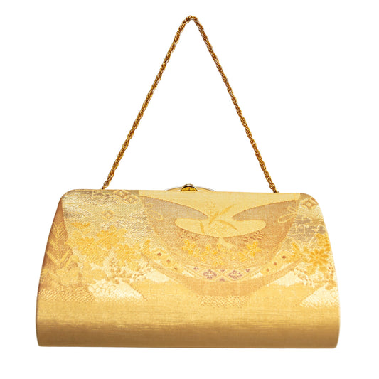 Gold clutch bag with floral pattern and gold rope handle on a white background