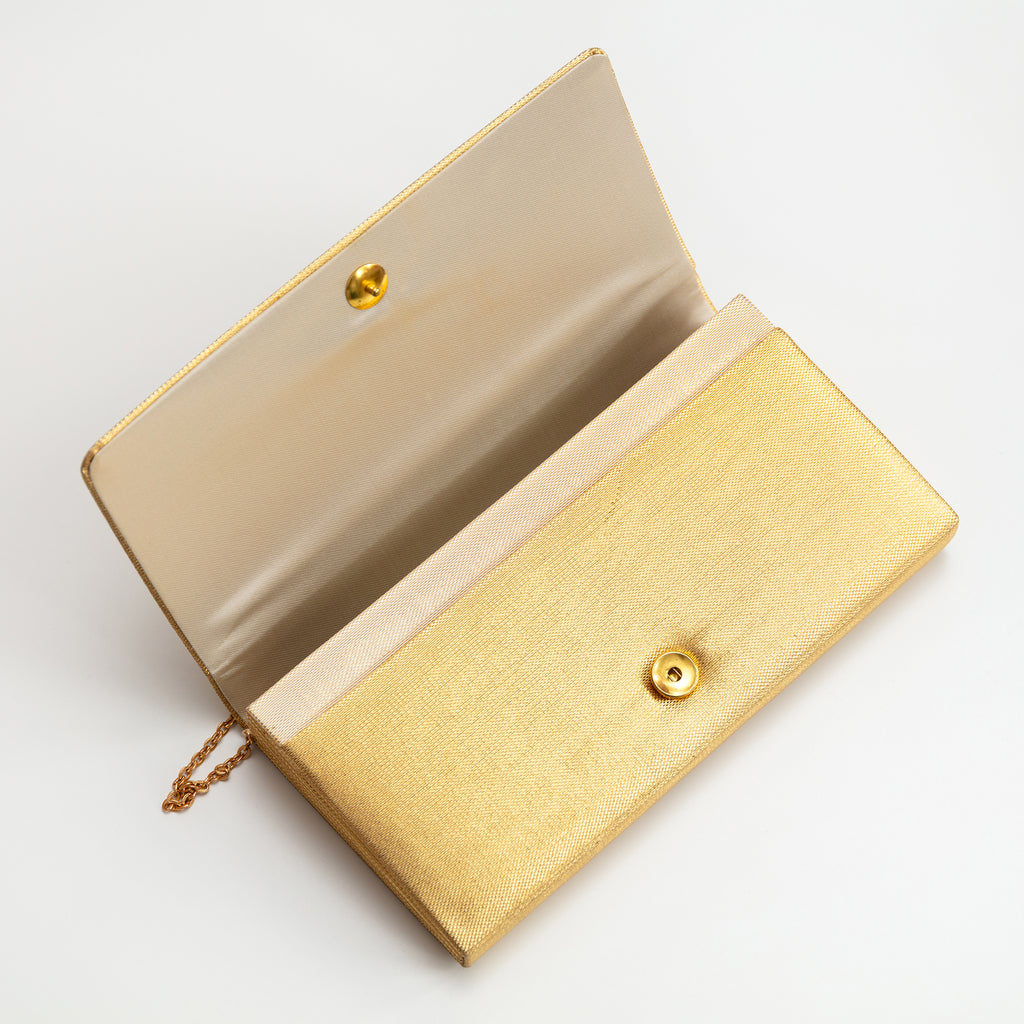 Close-up of gold metallic kimono floral embroidery on clutch’s front, showcasing intricate threadwork and textured fabric