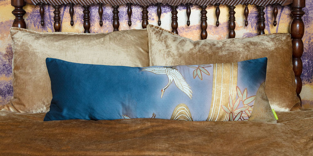 Decorative vintage kimono silk pillow on a bed