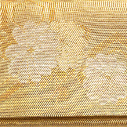Close-up of a textured gold fabric with floral patterns, detail of the front of the vintage Japanese kimono silk clutch bag.