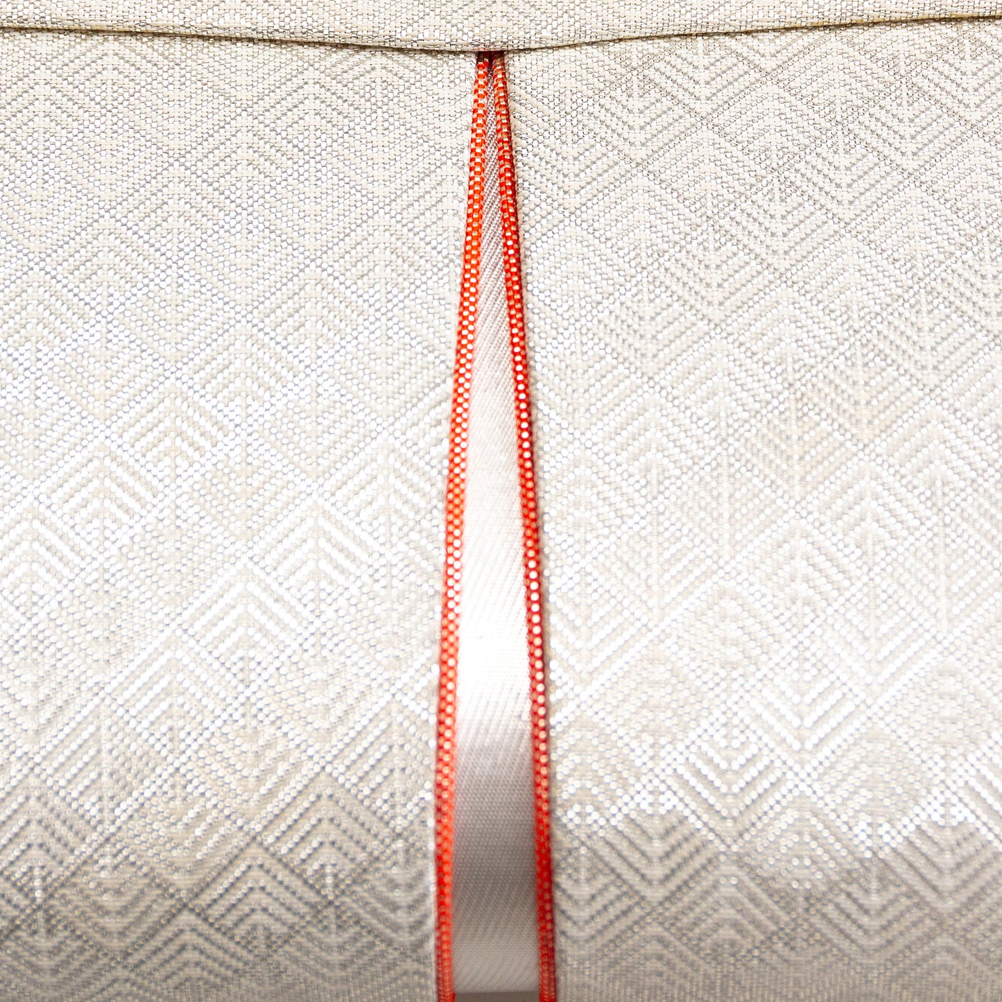 Close up of the vintage Japanese woven brocade surface of the clutch with orange piping accent.