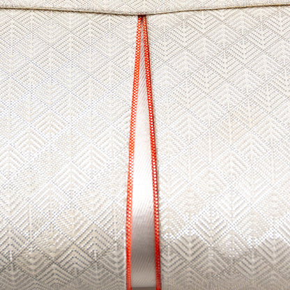 Close up of the vintage Japanese woven brocade surface of the clutch with orange piping accent.