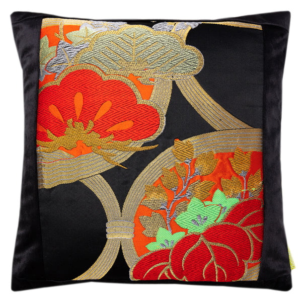 Black velvet cushion with a black silk panel with gold, red, orange and green embroidery of stylised pine and paulownia trees