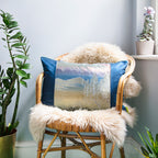 Close-up of the textured blue velvet fabric showcasing subtle silk sheen and soft folds on the cushion surface.