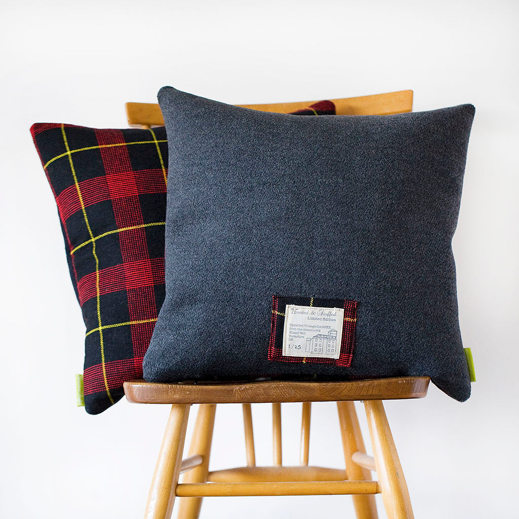 Close-up of grey wool tartan pattern highlighting vintage fabric texture and subtle color variations on the Gannex cushion.
