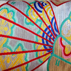 Close-up of yellow velvet fabric with vintage kimono silk fan embroidery highlighting intricate hand-stitching and textured