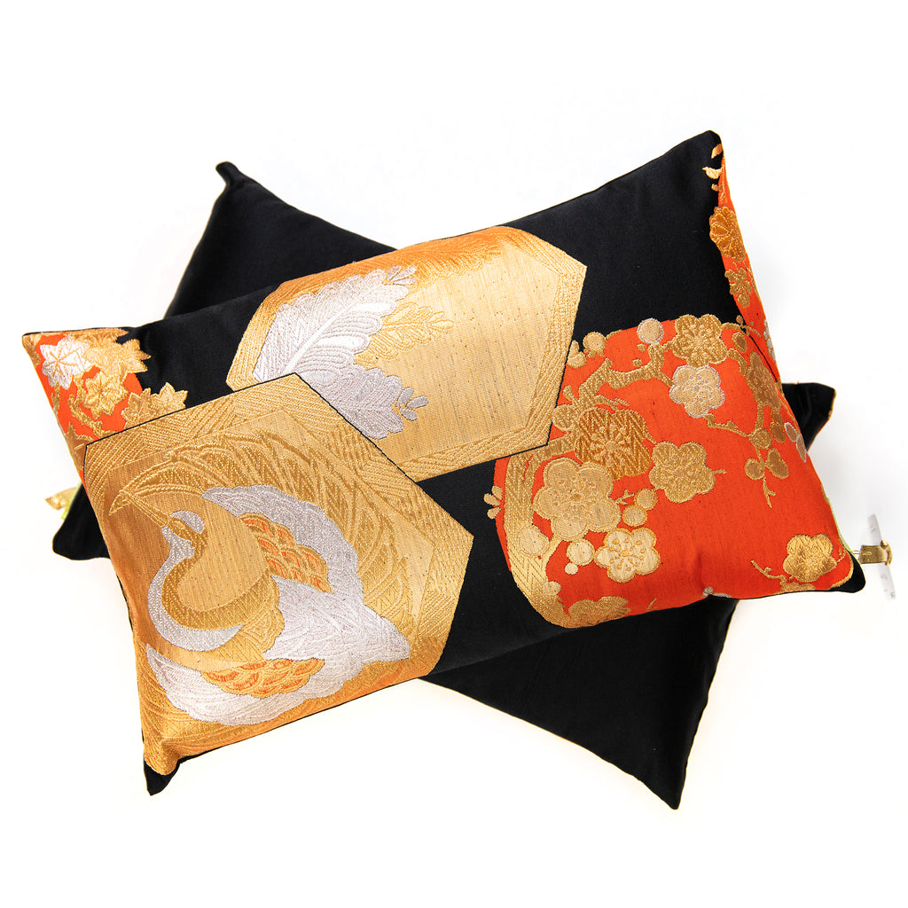 Close-up of black, gold, and orange silk embroidery highlighting intricate Chinoiserie motifs on the Obi cushion fabric