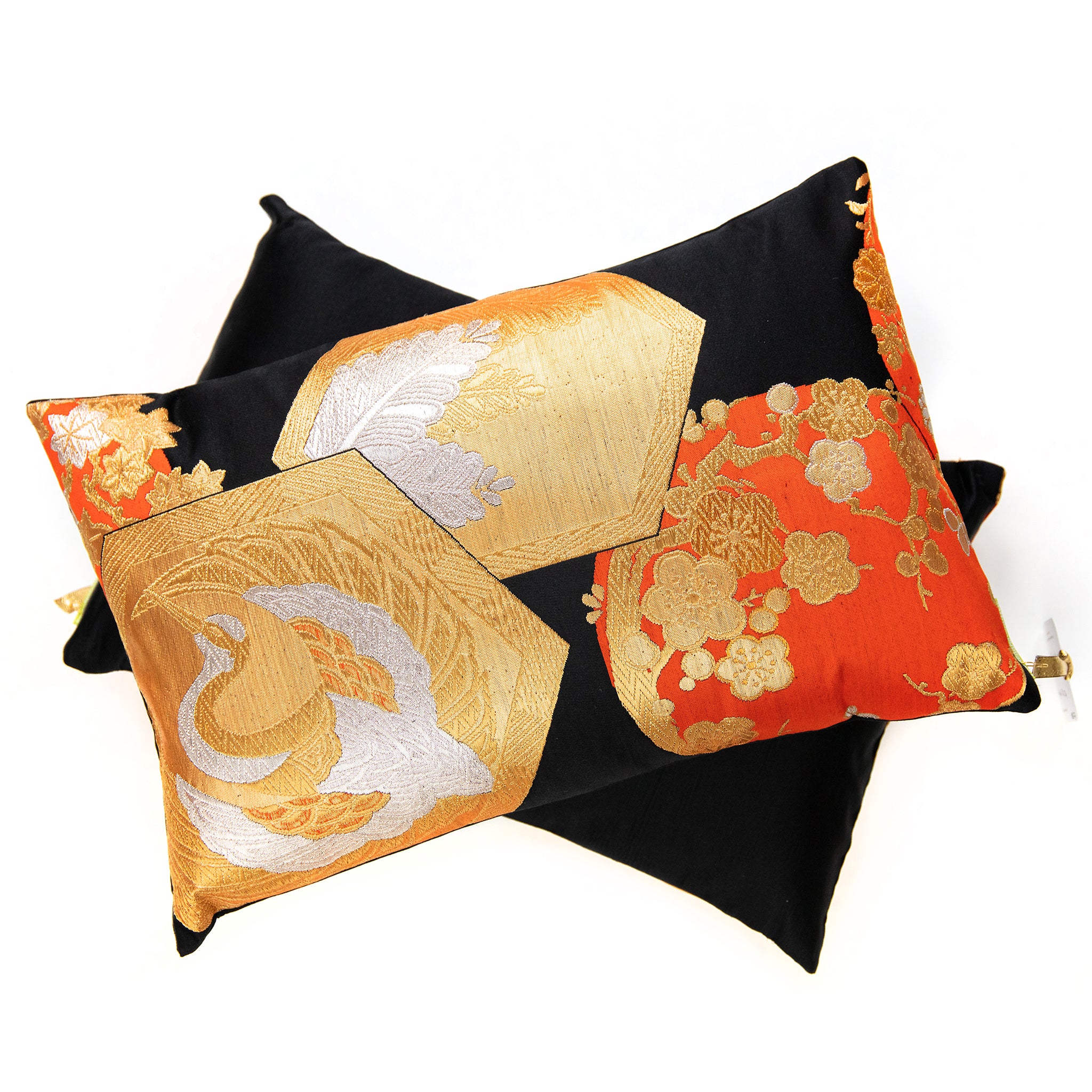 Close-up of black, gold, and orange silk embroidery highlighting intricate Chinoiserie motifs on the Obi cushion fabric