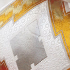 Close-up of gold embroidery detailing on the vertical edge of the Cream Silk Cushion, highlighting intricate metallic