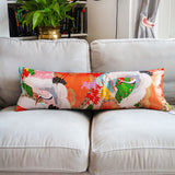 Orange bolster cushion with flying cranes in white and a teal blue velvet back by Hunted and Stuffed