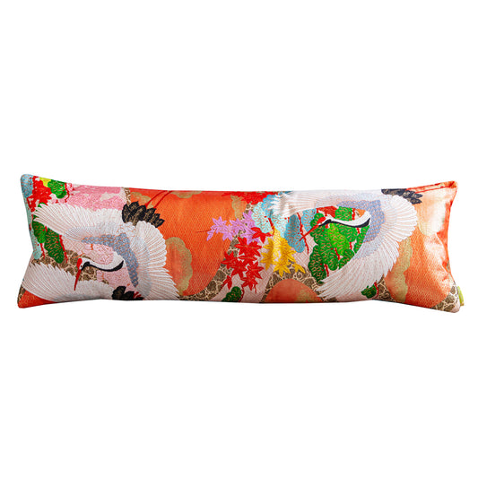 Orange kimono bolster cushion with flying cranes design and teal velvet reverse.