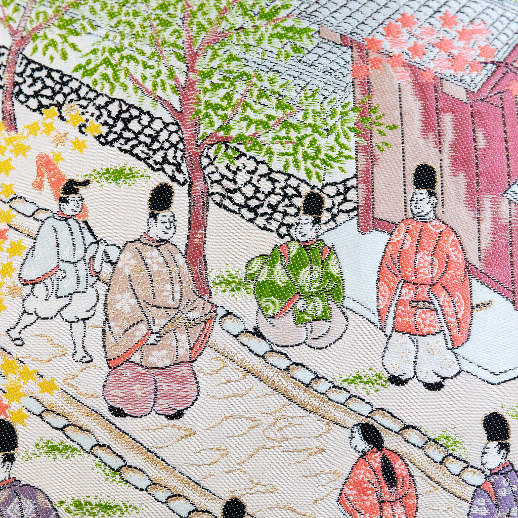 Close-up of intricate Nishijin silk weave highlighting the vibrant, textured embroidered street scene design on the 14-inch