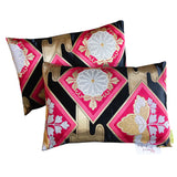 Pink obi pillow set in black silk with metallic gold accents.