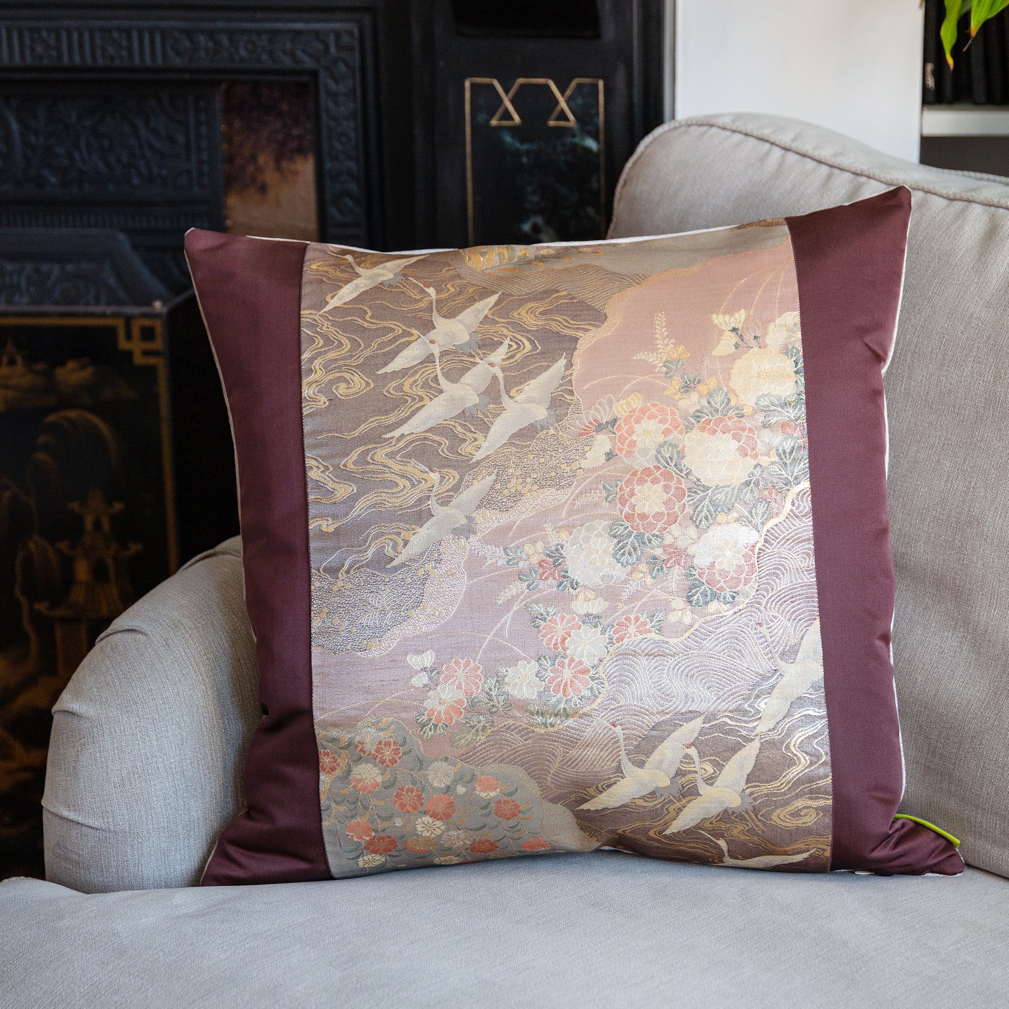 Close-up of the Purple Flying Cranes Pillow’s rose gold silk embroidery highlighting intricate crane feather details and