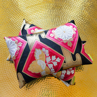 Pair of two throw pillows. obi cushions on gold background.