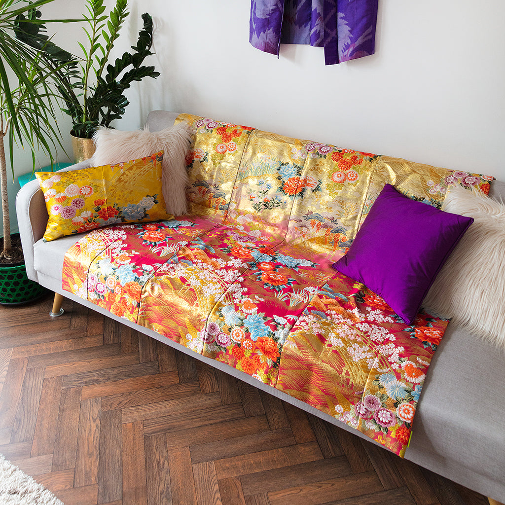 Close-up of the silky, upcycled fabric texture highlighting the intricate weave and subtle sheen of the vintage silk throw