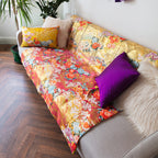 Close-up of the luxurious silk fabric's intricate upcycled floral embroidery detailing the kimono's sleeve cuff.