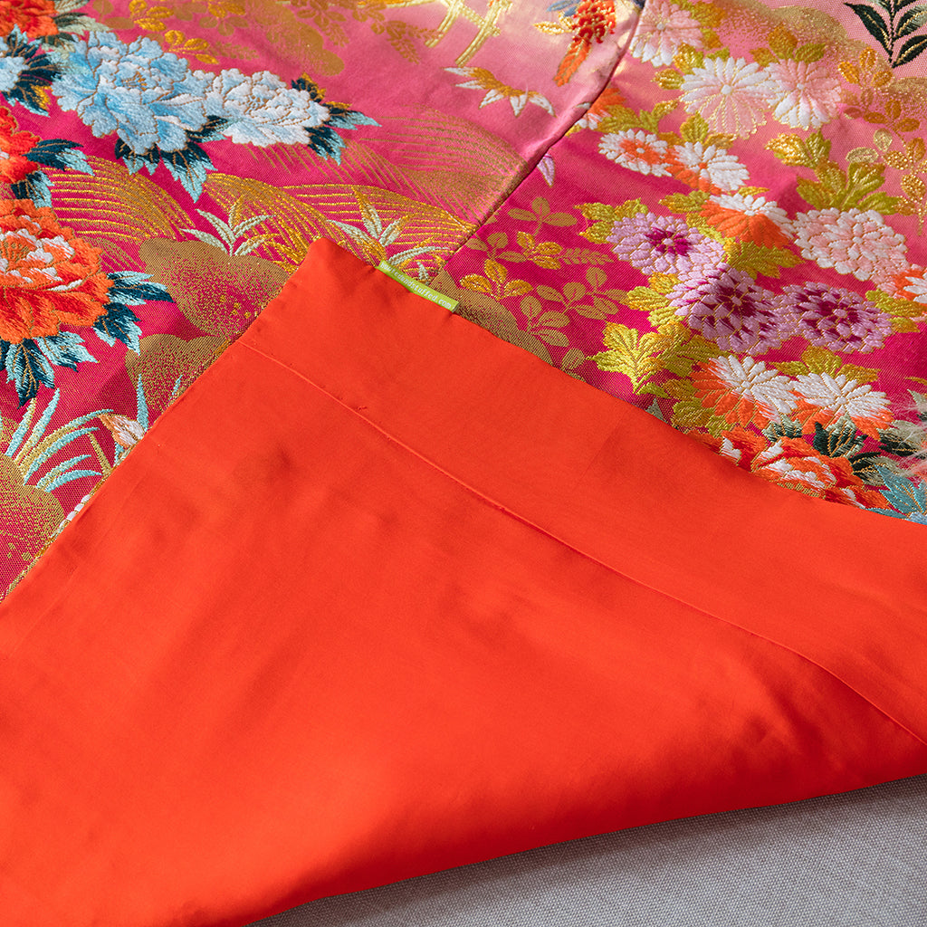 Close-up of intricate silk embroidery and textured fabric details highlighting the kimono’s upcycled craftsmanship and luxe