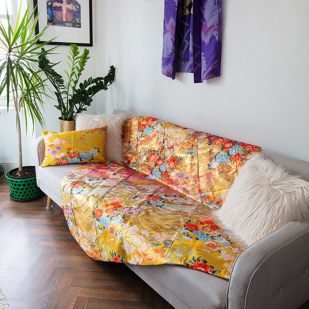 Close-up of intricate silk kimono embroidery with shimmering threads and vintage floral motifs, highlighting craftsmanship