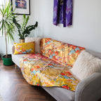 Close-up of intricate silk kimono embroidery with shimmering threads and vintage floral motifs, highlighting craftsmanship