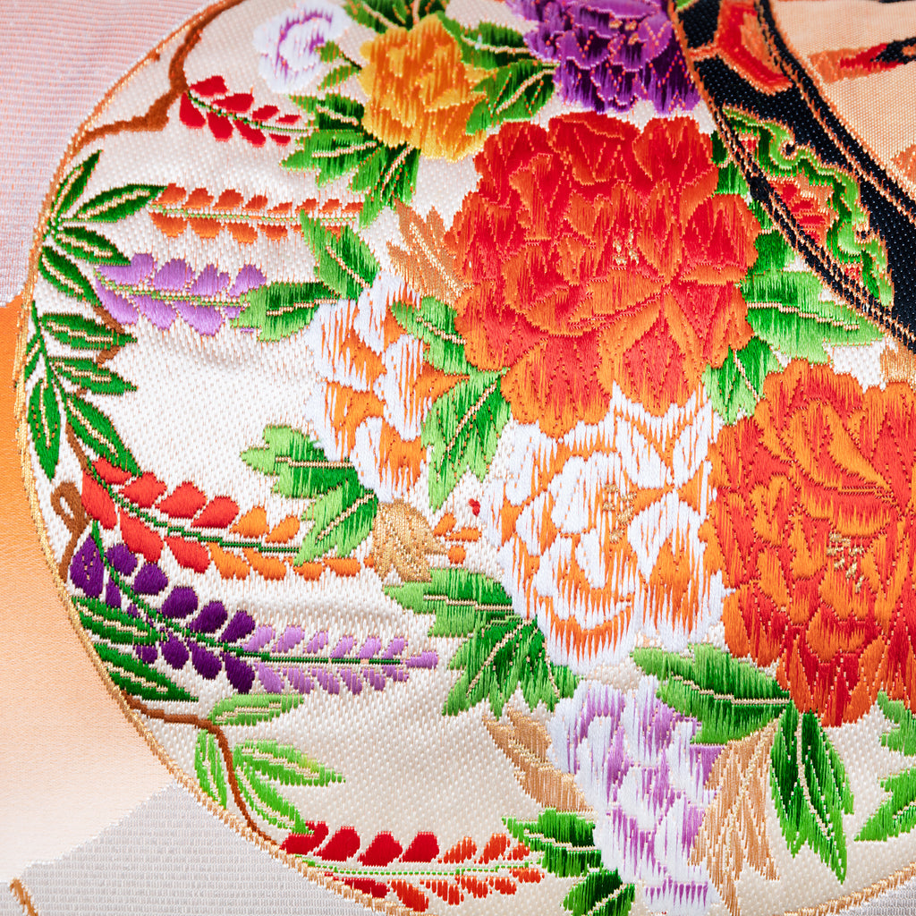 Close-up of the vibrant orange ombre silk fabric showcasing its smooth, lustrous texture and subtle silver bamboo pattern