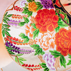 Close-up of the vibrant orange ombre silk fabric showcasing its smooth, lustrous texture and subtle silver bamboo pattern