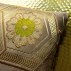 Close-up of the gold geometric pattern on the chartreuse velvet fabric highlighting textured surface and intricate stitching