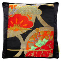 Black silk and black velvet japanese pillow with red flowers by Hunted and Stuffed, London. Shows the gold line of the end of the obi.