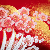 Close up of woven blossom in pink with gold acccents over a red silk base. A vintage obi repurposed as a pillow.