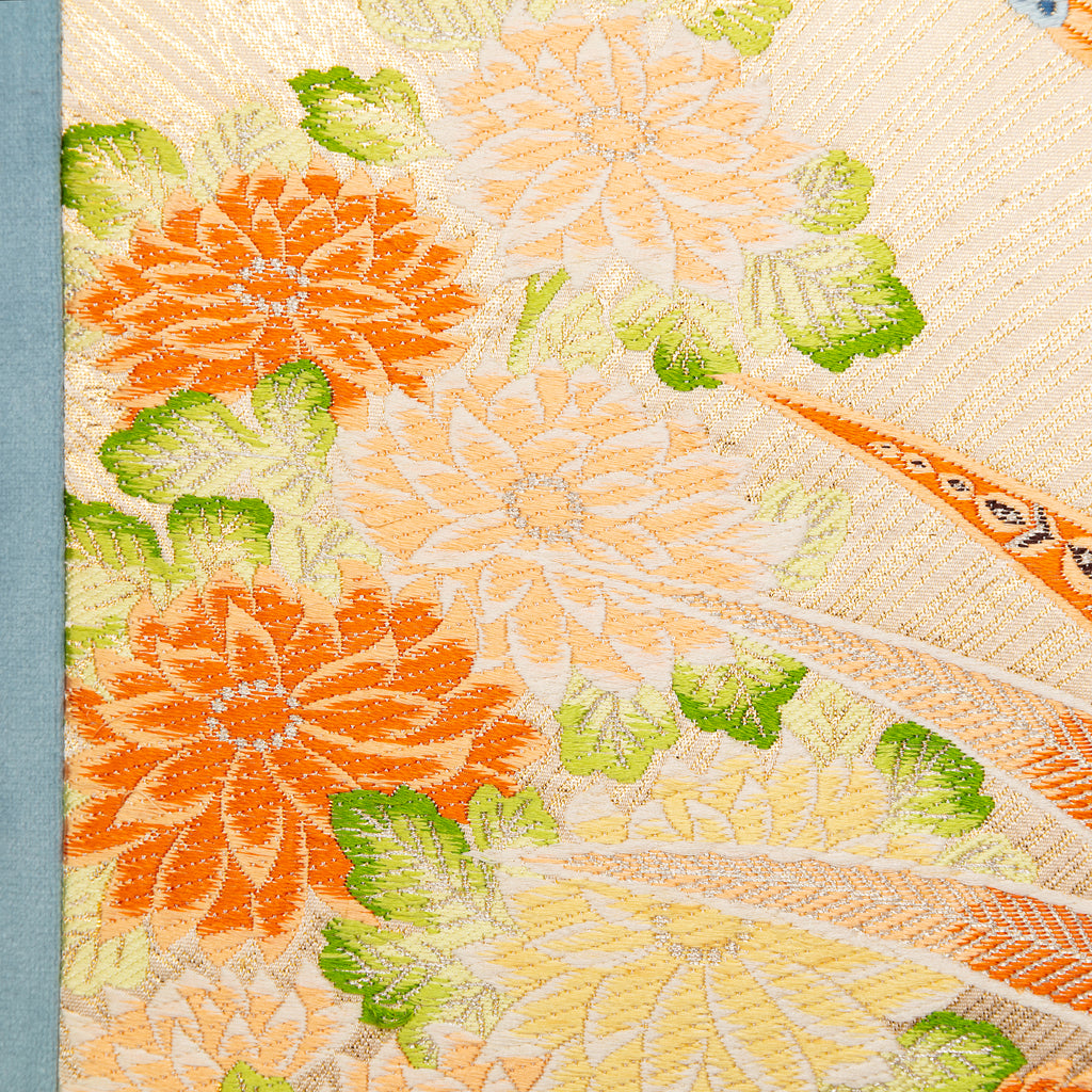 Close-up of cream Maru Obi silk and duck egg blue velvet fabric with subtle stitching details on the Flying Pheasants
