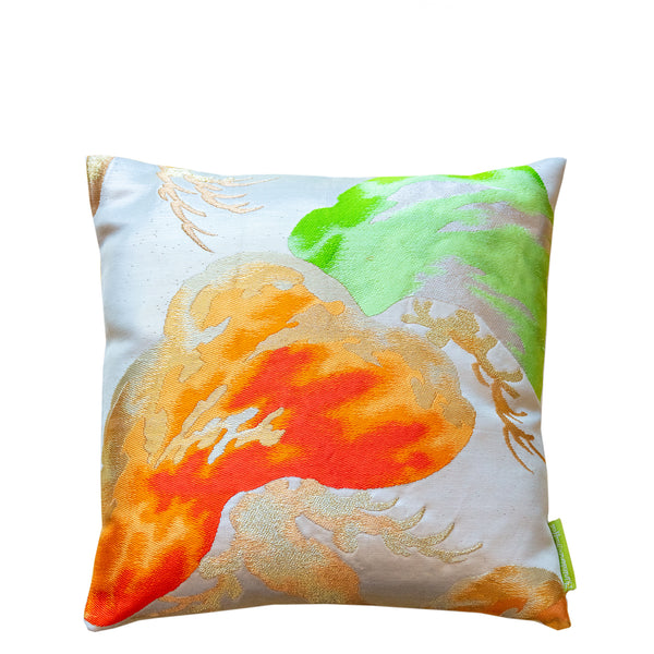 A 12 inch cream silk throw pillow with orange and green matsu pine decoration by Hunted and Stuffed.
