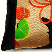 detail of black obi pillow, gold kiri leaf with green accent, woven obi design