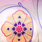 Close-up of the pink ombre silk fabric revealing smooth texture and subtle gold floral embroidery detail on the cushion's