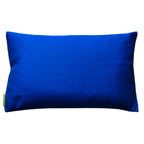 Close-up of gold accents and intricate silk weave on the top edge of the electric blue silk pillow showing detailed