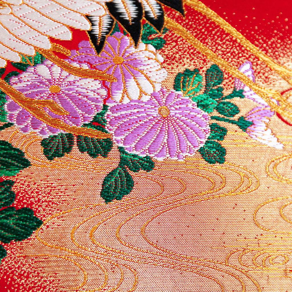 Close-up of red silk embroidery details on black velvet surface of the wedding Uchikake square cushion, showing intricate