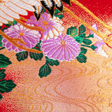 detail of purple flowers over gold and red silk base, part of an obi cushion by hunted and stuffed