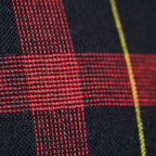 Close-up of vintage navy wool tartan fabric detail highlighting rich texture and subtle color variations in the cushion's