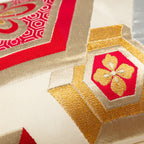 Close-up of red hexagon Kiri flower embroidery on the Cream Silk Obi Pillow, showcasing intricate stitching detail and