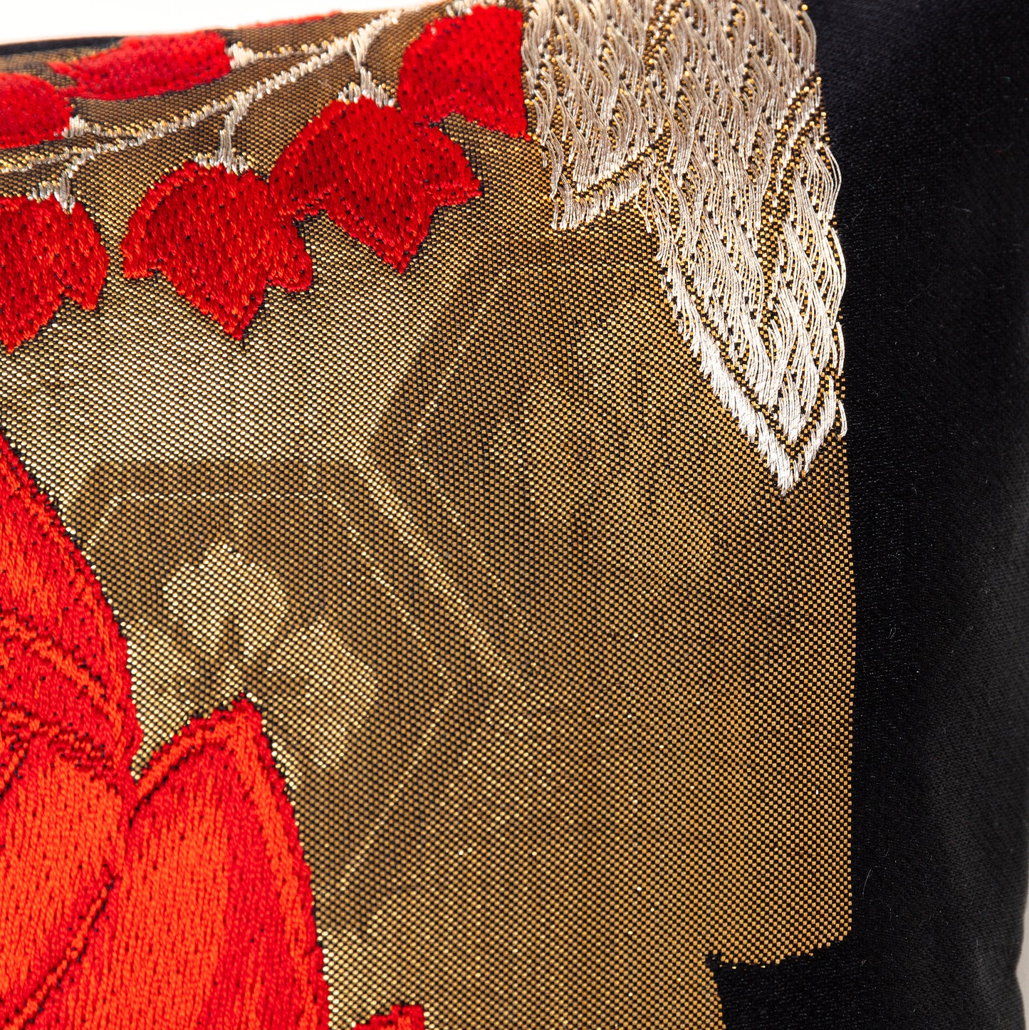 Gold accent cushion with red and black details.